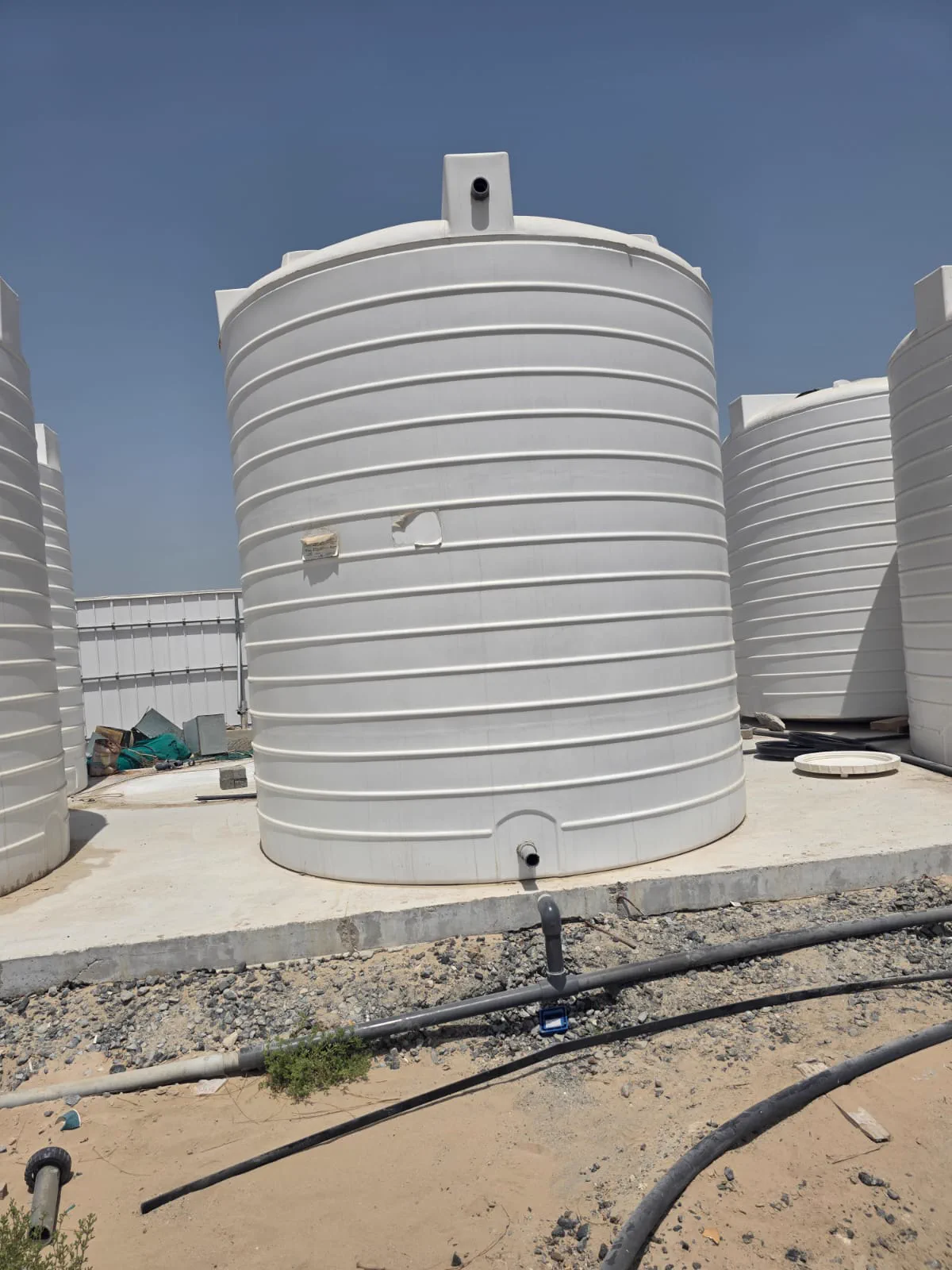 White vertical HDPE water tank connected on site